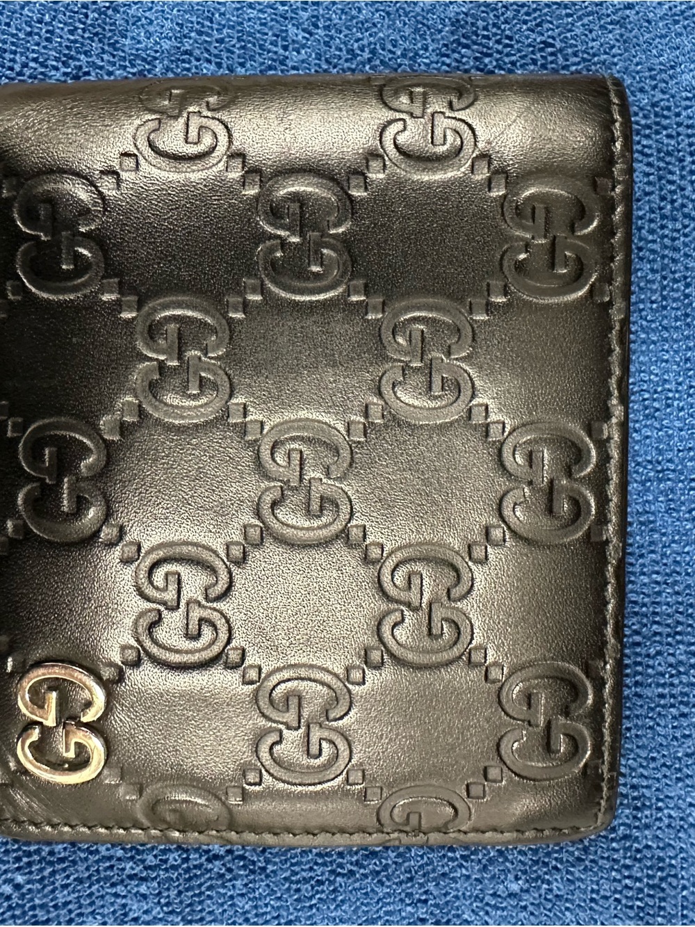 Gucci Black Embossed GG Leather Men's Bifold Wallet with Gold Accent